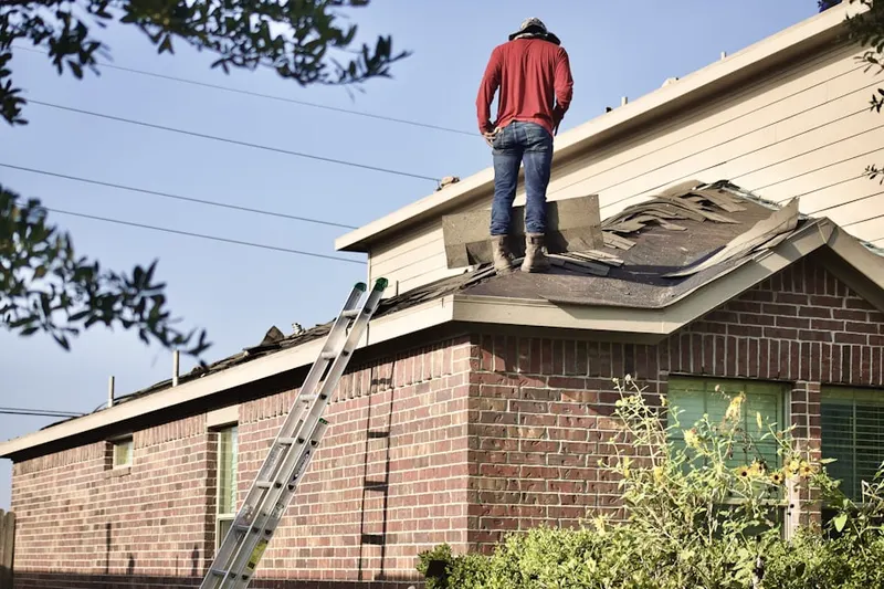 Professional roofer working on a residential roof in Southeast Hoboken